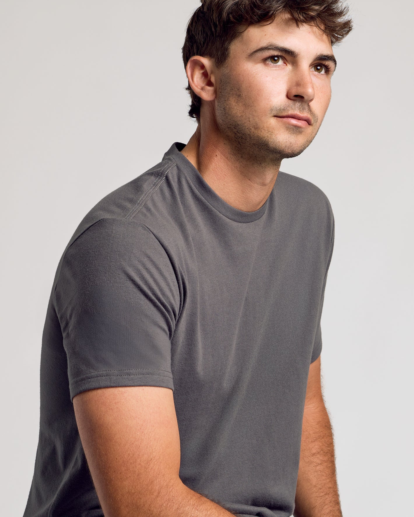 Carbon Short Sleeve Tall Curved Hem Crew worn by a young man.