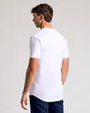 Man wearing White Classic Tall Curved Hem Crew, showcasing added length.