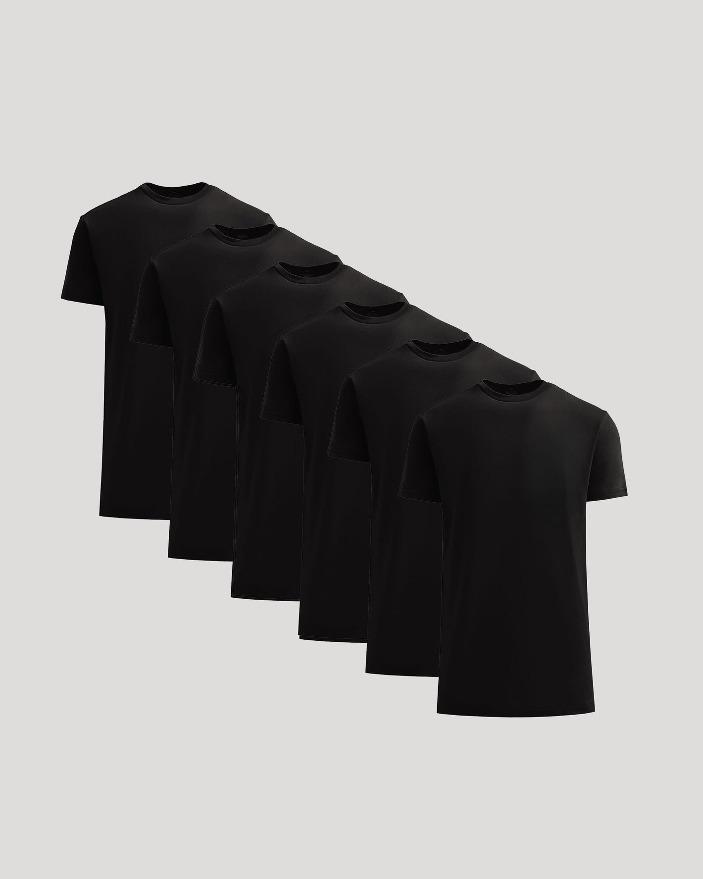 Set of six black t-shirts on a light gray background