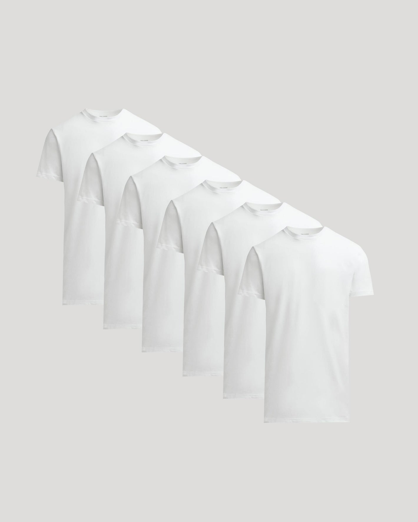 Set of white t-shirts on a light gray background