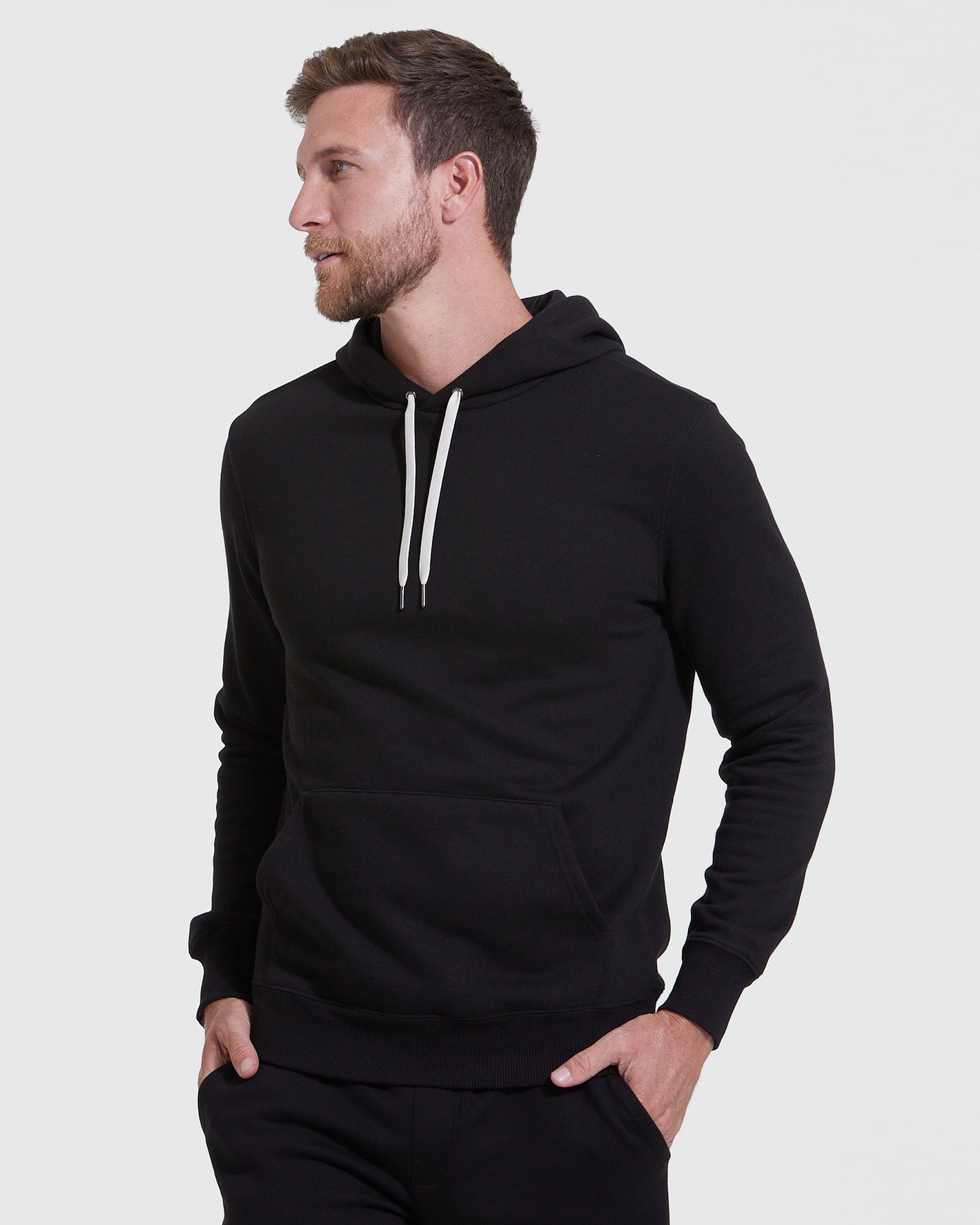 Man wearing black pullover hoodie from Hoodie & Active Jogger 3-Pack.