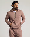 Man in Slate Mauve Fleece French Terry Pullover Hoodie with sweatpants.