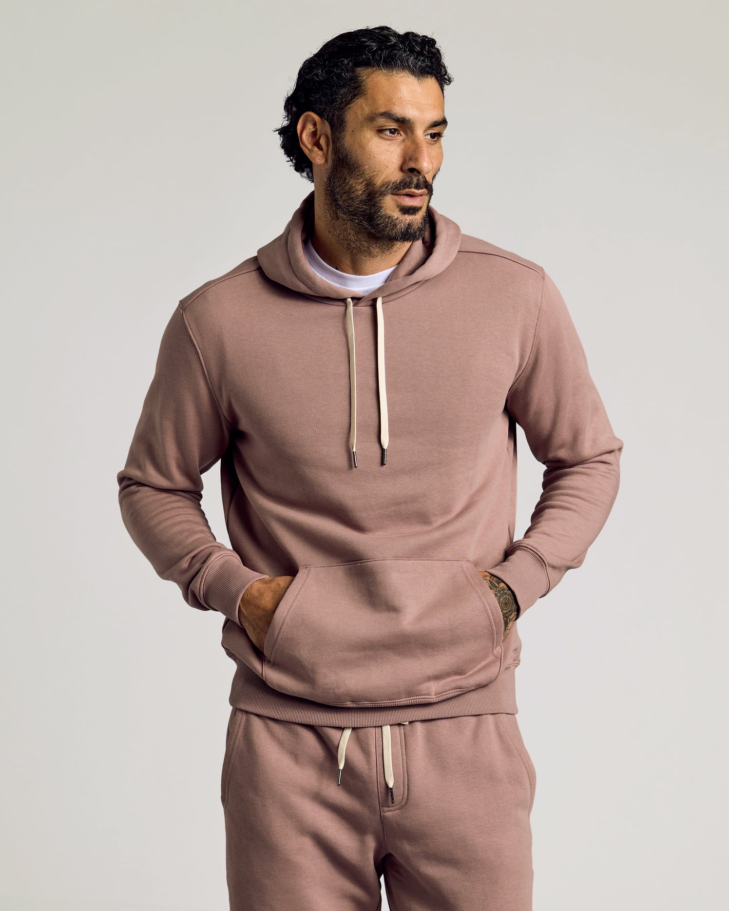 Man in Slate Mauve Fleece French Terry Pullover Hoodie with sweatpants.