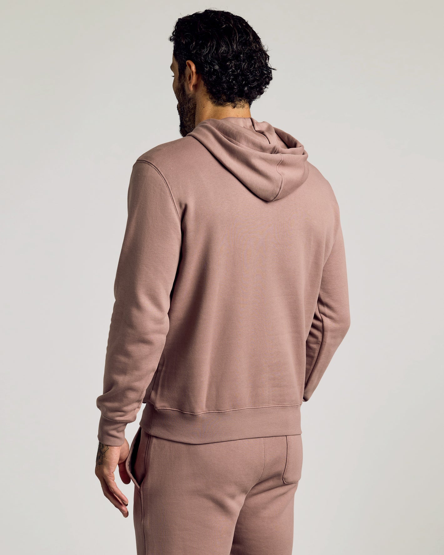 Man wearing Slate Mauve Fleece French Terry Pullover Hoodie, hood down.