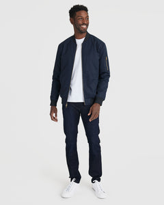True ClassicMan modeling Navy Bomber Jacket with jeans and sneakers.