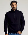 Man wearing The Fleece Fit 3-Pack's black quarter-zip pullover.