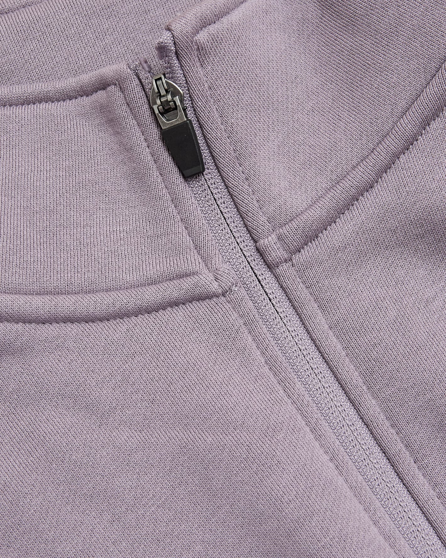 Thistle Half Zip Fleece Sweatshirt close-up showing zipper and stitching.