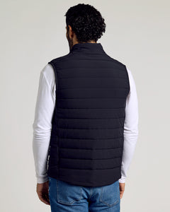 True ClassicBlack Puffer Vest over white shirt and jeans, showing quilted design.