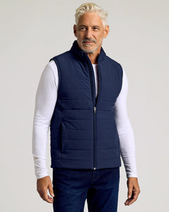 True ClassicNavy Puffer Vest on middle-aged man over white T-shirt.