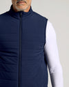 Navy Puffer Vest over white shirt, showcasing sleek design.