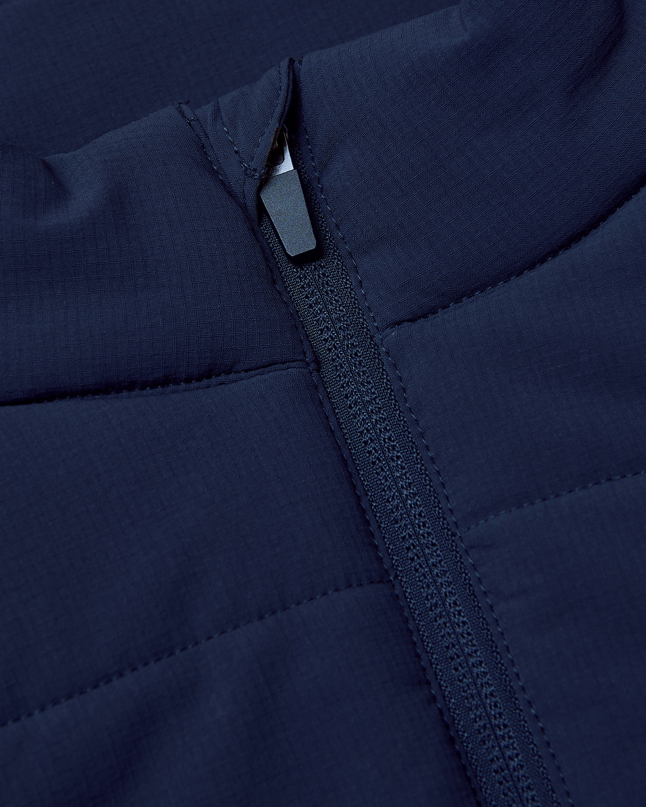 Navy Puffer Vest fabric with quilted panels and zipper.