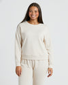 Woman wearing Womens Oatmeal Slouch Pullover Crew, smiling, facing camera.
