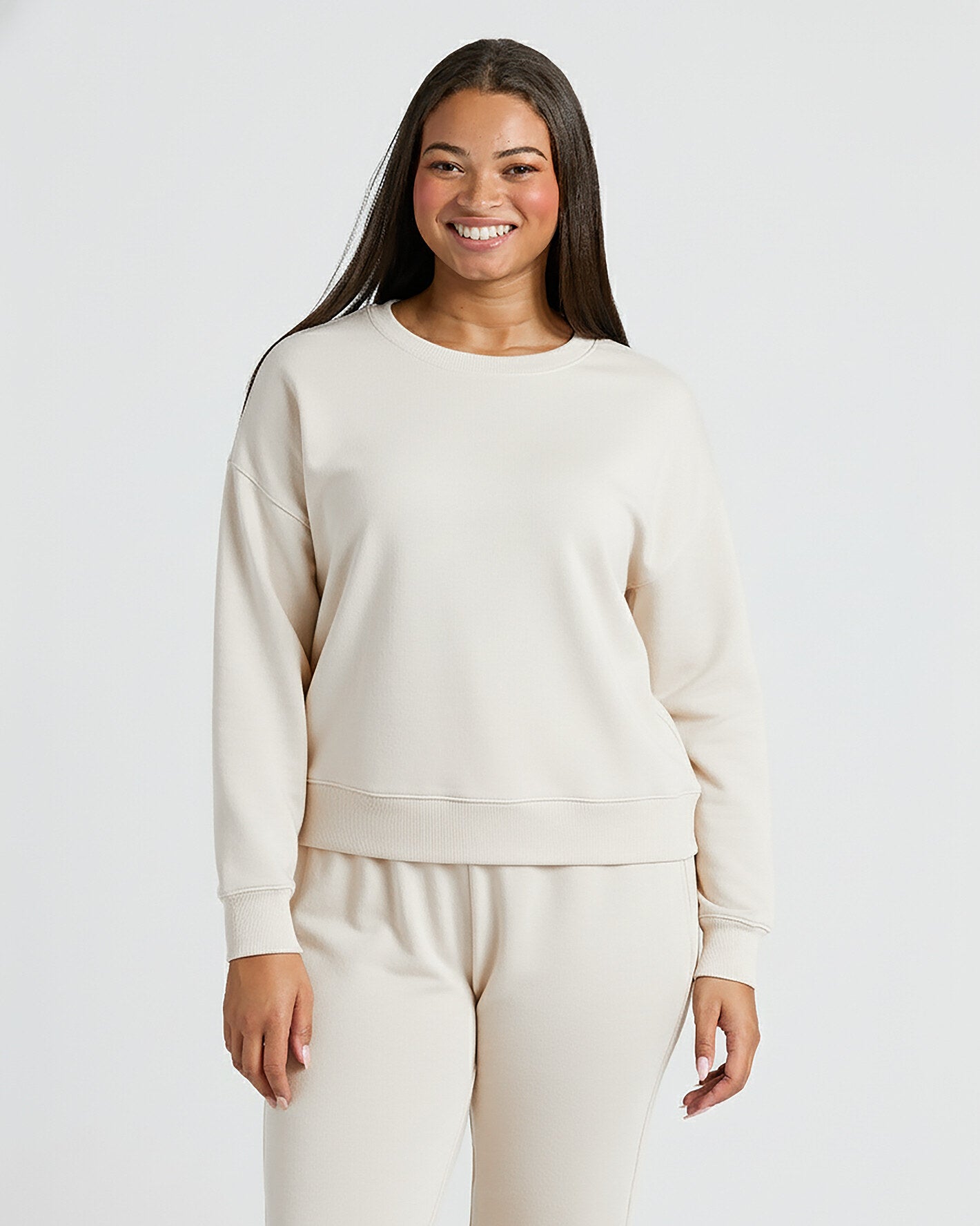 Woman wearing Womens Oatmeal Slouch Pullover Crew, smiling, facing camera.
