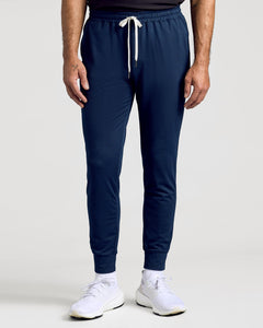 True ClassicDark Heather Navy joggers with drawstring, cuffed ankles, and white sneakers.