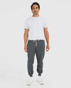 Man wearing Charcoal Heather Gray Fleece French Terry Joggers with white T-shirt.