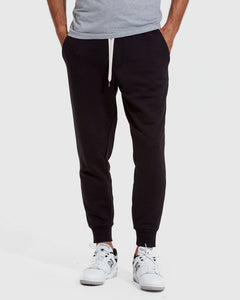 True ClassicPerson wearing black jogger pants and white sneakers on a white background