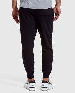 True ClassicMan wearing a gray t-shirt and black pants on a white background