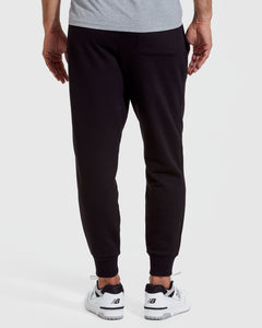 True ClassicMan wearing a gray t-shirt and black pants on a white background