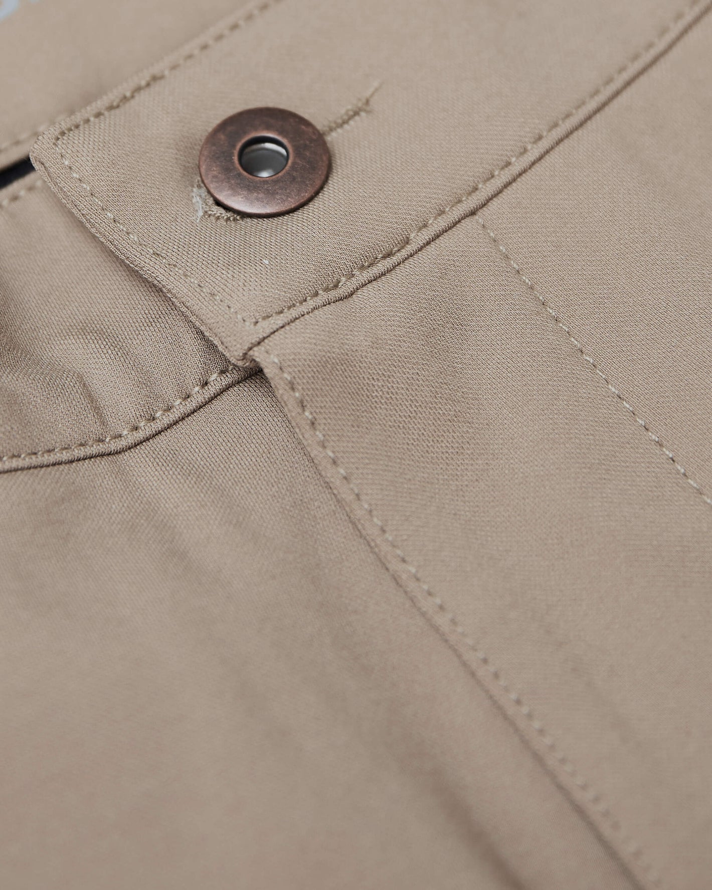 Khaki Commuter Pants' waistband and pocket with metal snap button.
