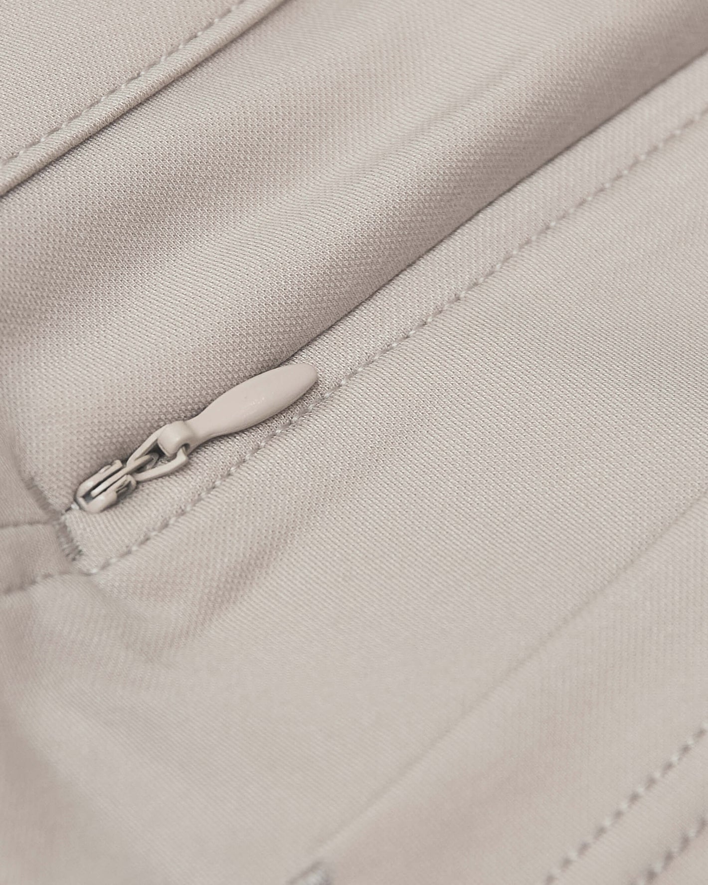 Sandstone Commuter Pants pocket with zipper and precise stitching detail.