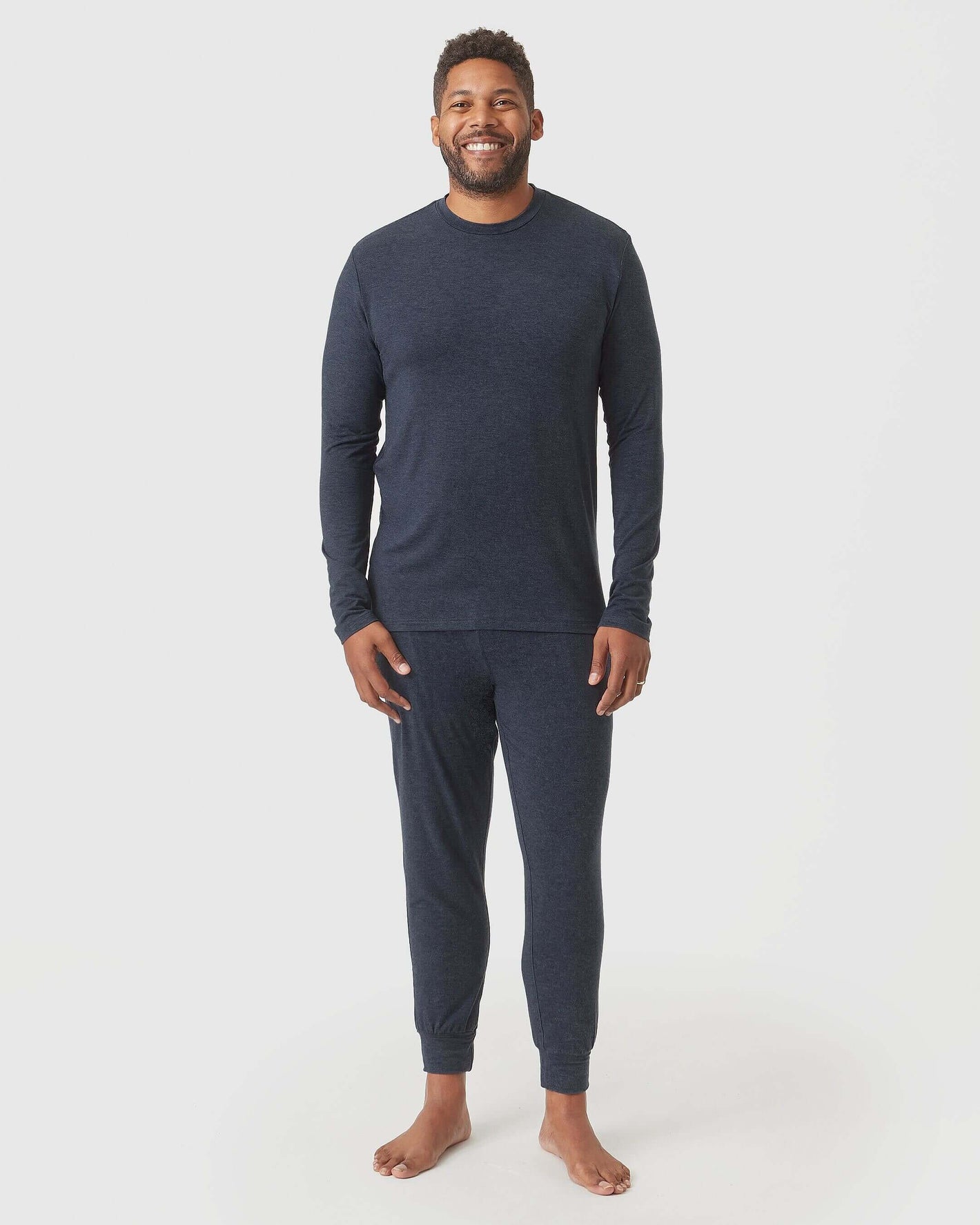Heather Navy Loungewear Jogger worn by smiling man, barefoot, relaxed stance.