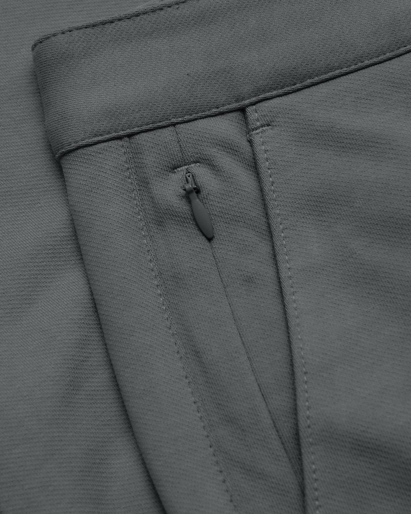 Carbon Slim Chino Pants 2.0 with zippered pocket and waffle texture.