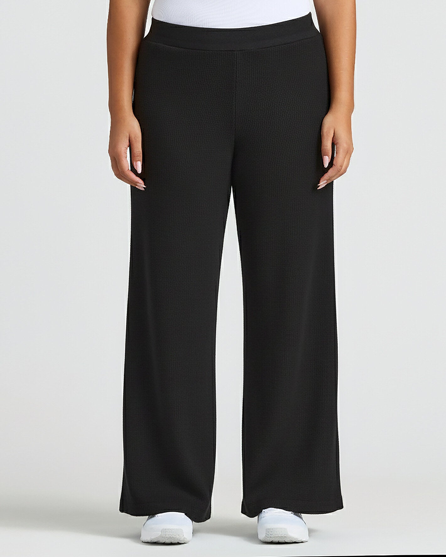 Womens Black Waffle Wide Leg Pants styled with white top and sneakers.