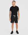 Man wearing 7 All Black Active Quick Dry Shorts, looking left.