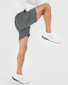 7 All Carbon Active Quick Dry Shorts, shown in athletic pose.
