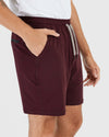 Wearing Dark Heather Burgundy Active Comfort Shorts with drawstring and pockets.