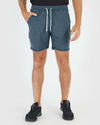 Man in Dark Heather Indigo Active Comfort Shorts with sneakers.