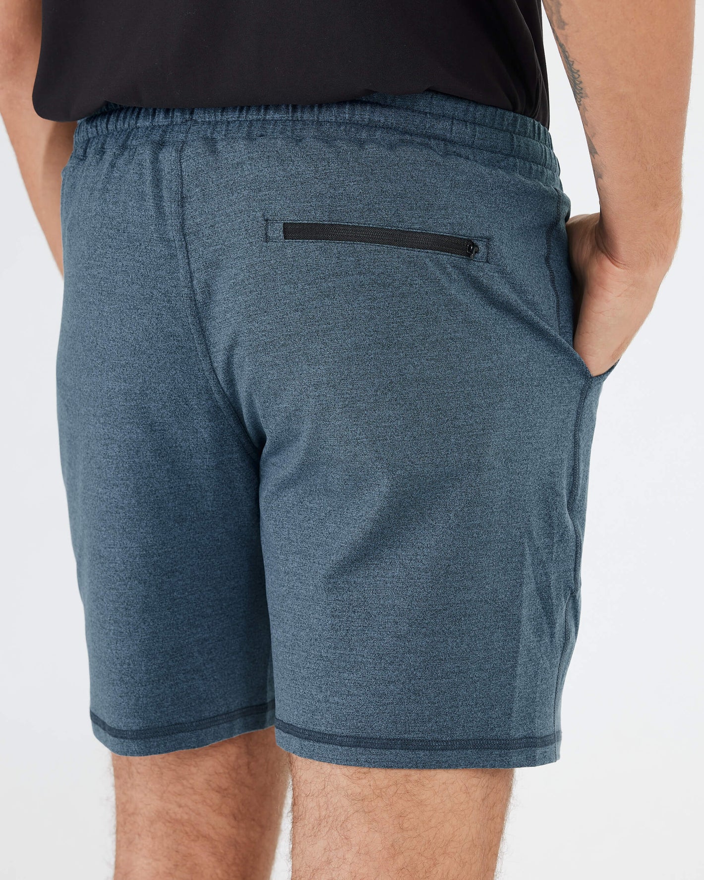 Man wearing Dark Heather Indigo Active Comfort Shorts with pockets, rear view.