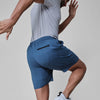 Man wearing Stone Blue Active Comfort Shorts, showcasing zip pocket and athletic movement.