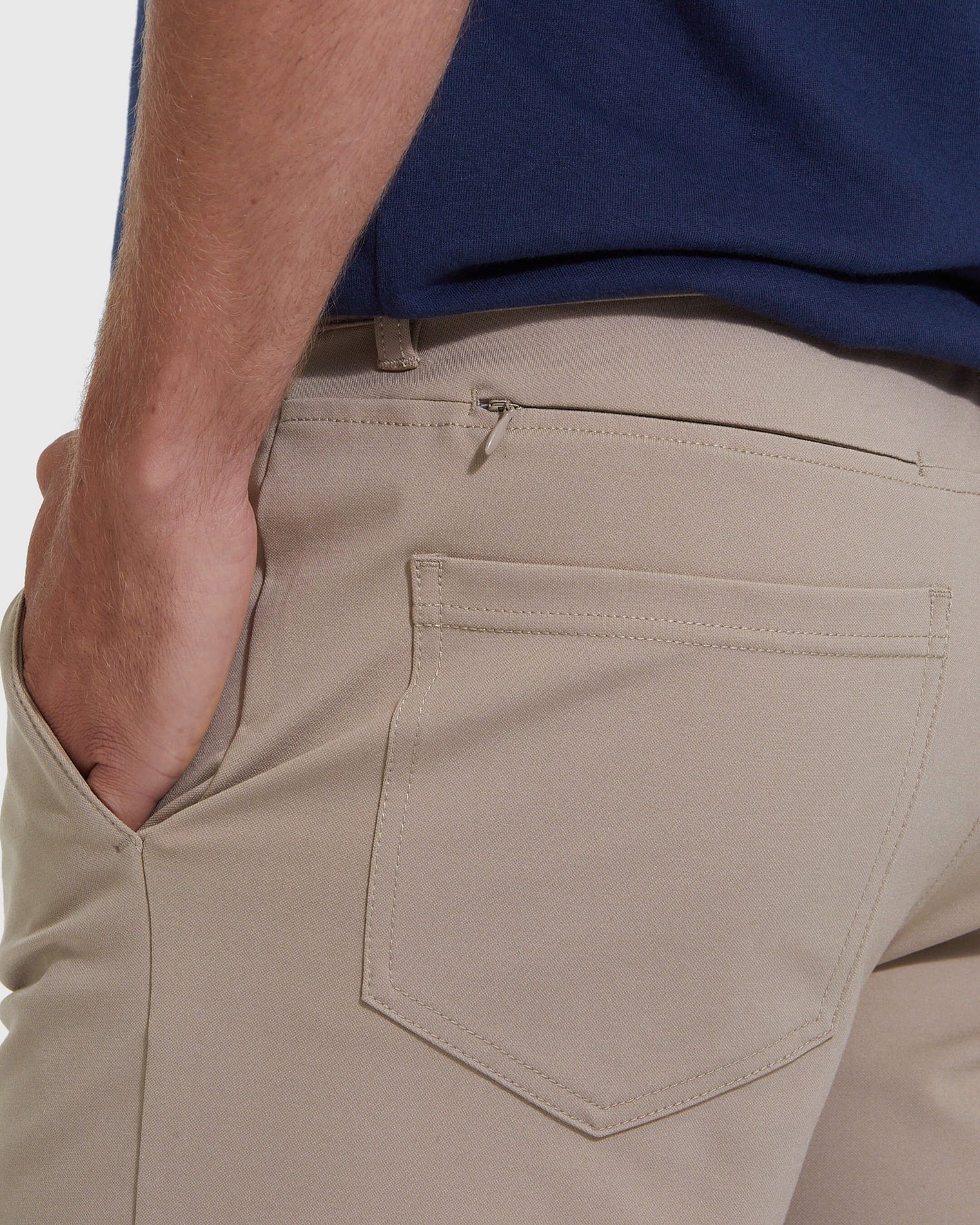 Khaki Commuter Short with rear pocket detailing and hand in front pocket.