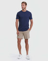 Man wearing Khaki Commuter Short with navy T-shirt and white sneakers.