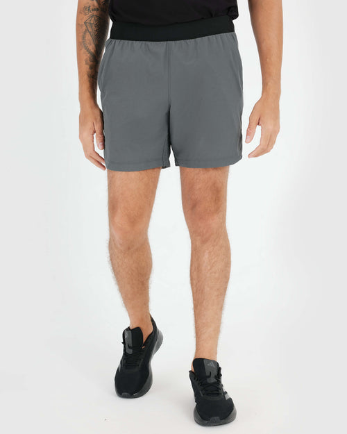 7 Carbon Active Training Short with black waistband and running shoes.