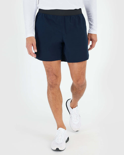 7 Navy Active Training Short on person walking, showcasing athletic fit.