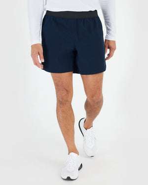 7 Navy Active Training Shorts 2.0 in a walking pose.