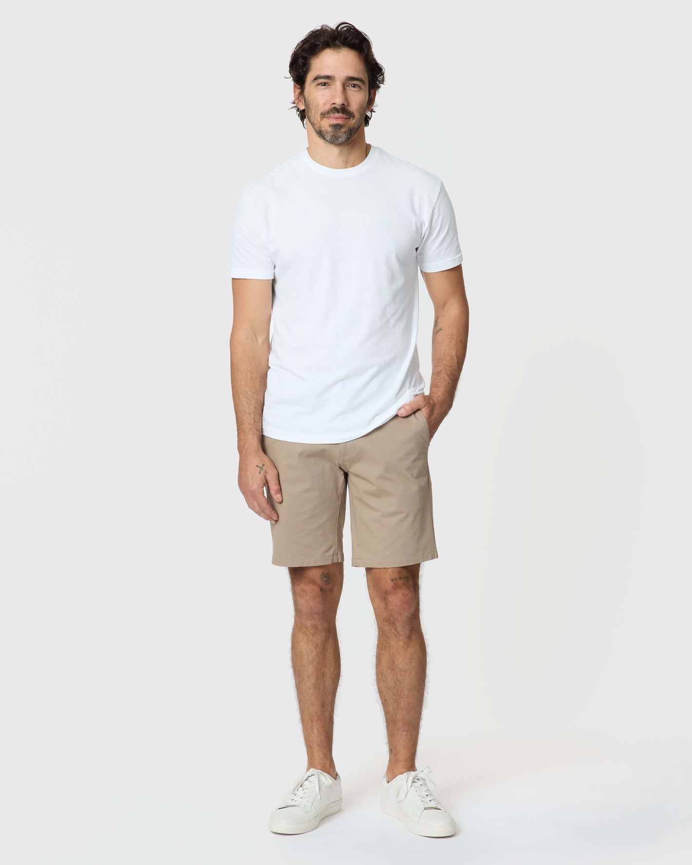 Man wearing Khaki Twill Short, white T-shirt, sneakers; casual, structured style.