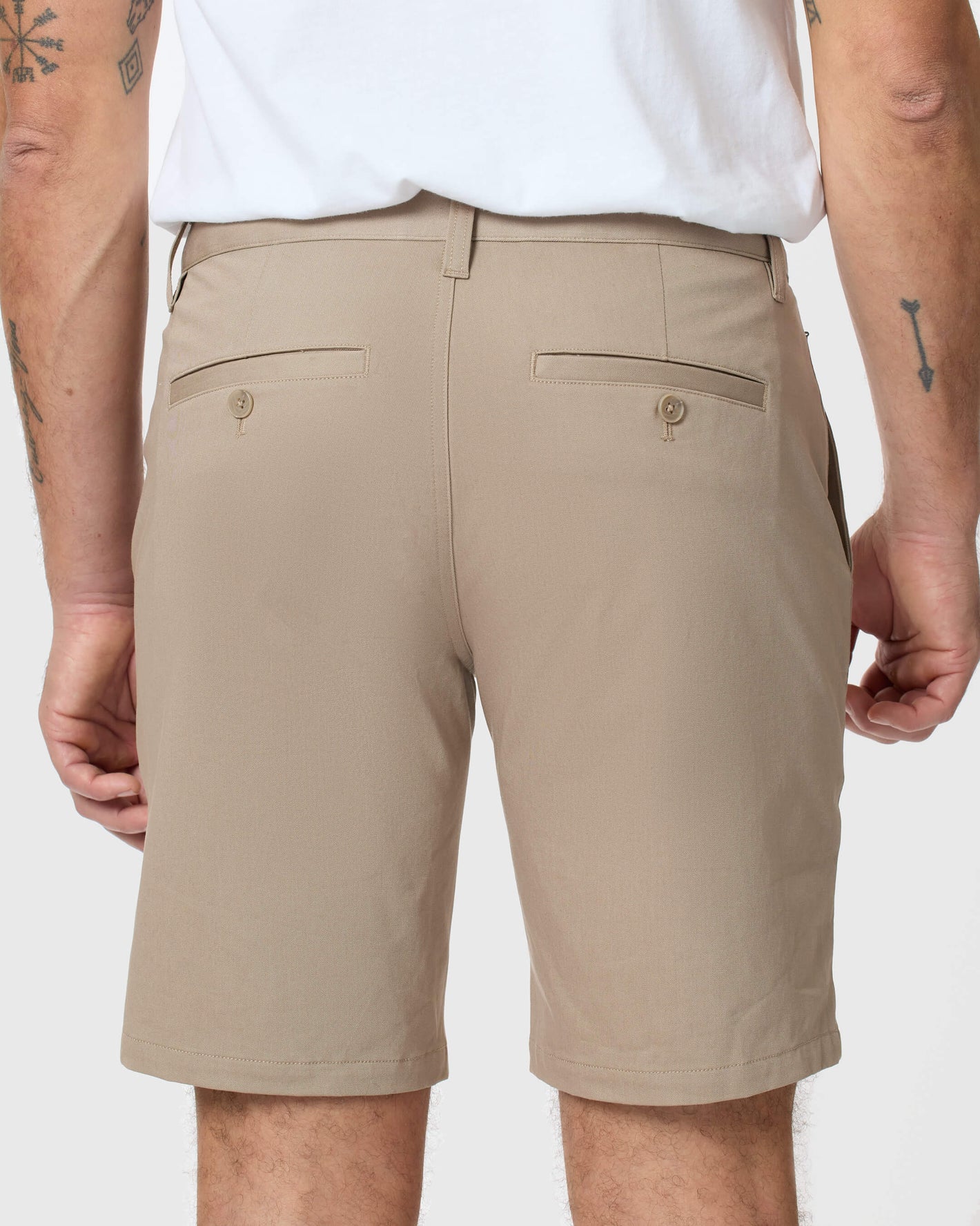 Khaki Twill Short with button-closure welt pockets and tattoos visible.