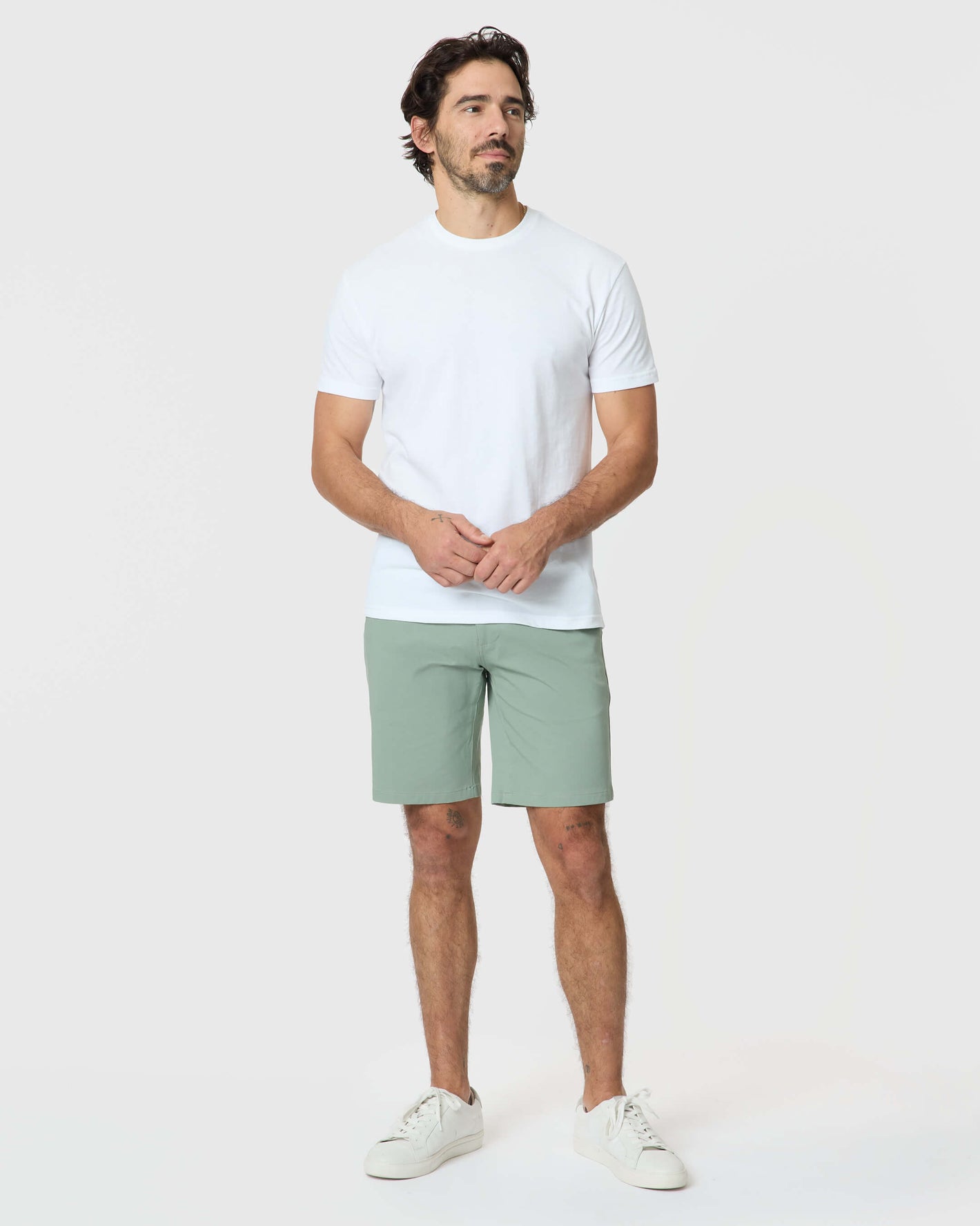 Man wearing Meadow Twill Short with white T-shirt and sneakers.