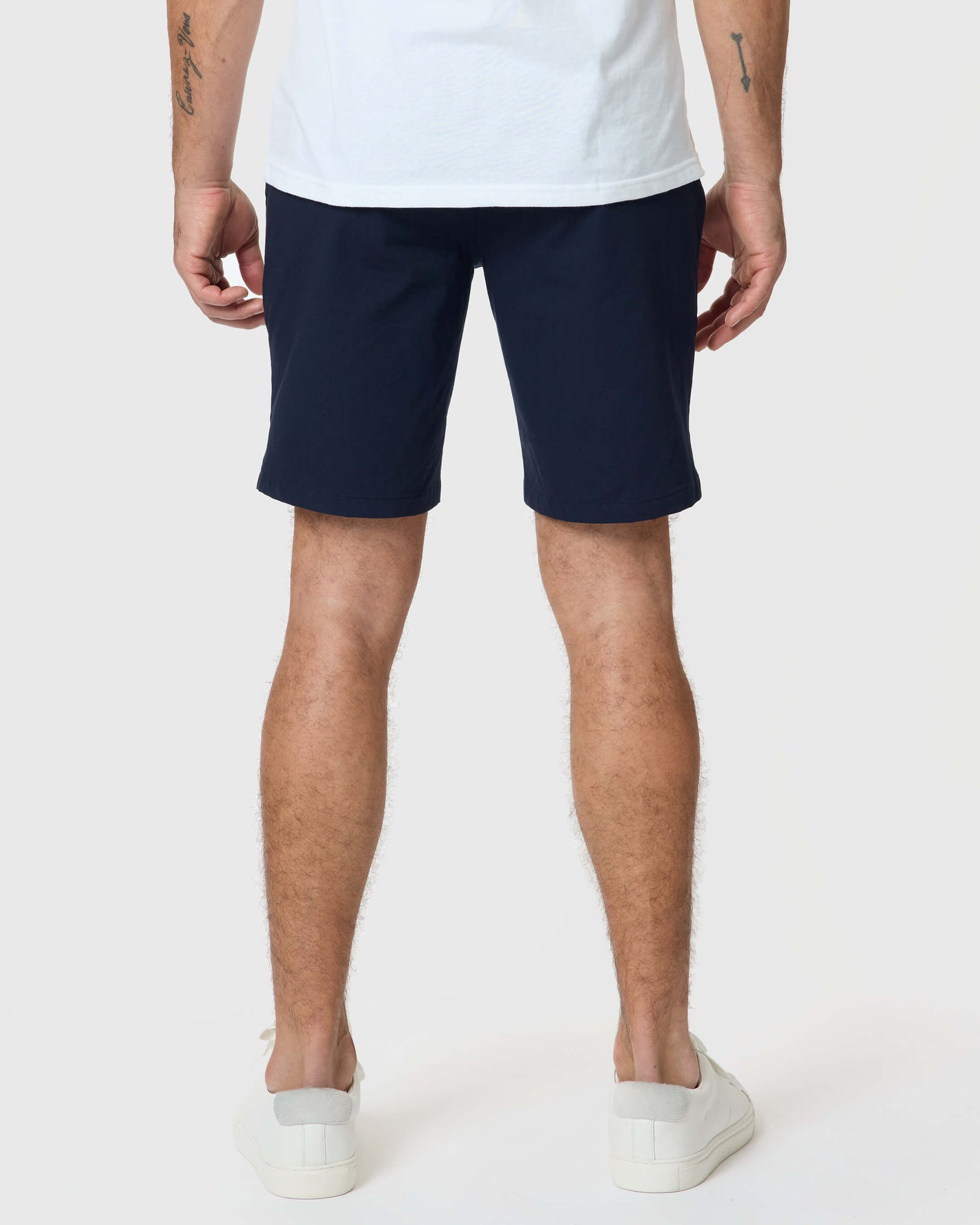 Navy Twill Short styled with white sneakers and visible tattoos.