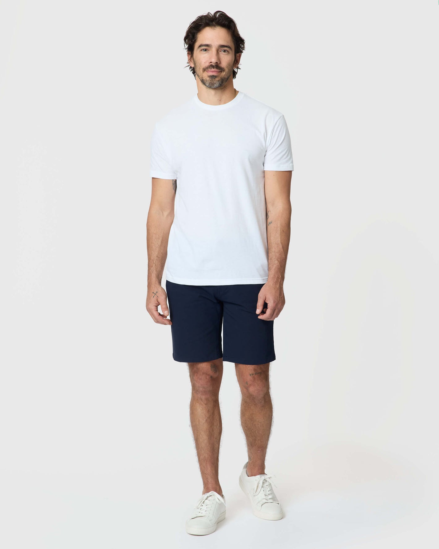 Man wearing Navy Twill Short with white t-shirt and sneakers.