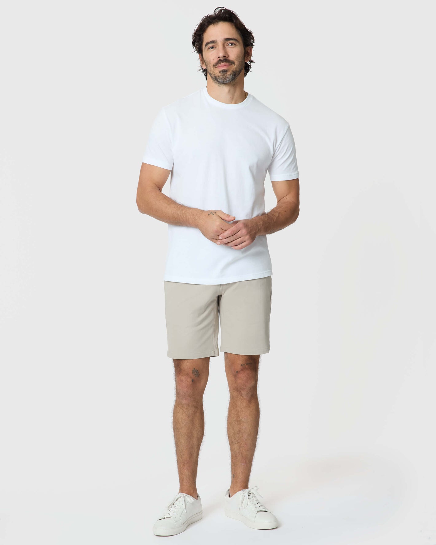 Man wearing Sandstone Twill Short and white T-shirt, standing casually.