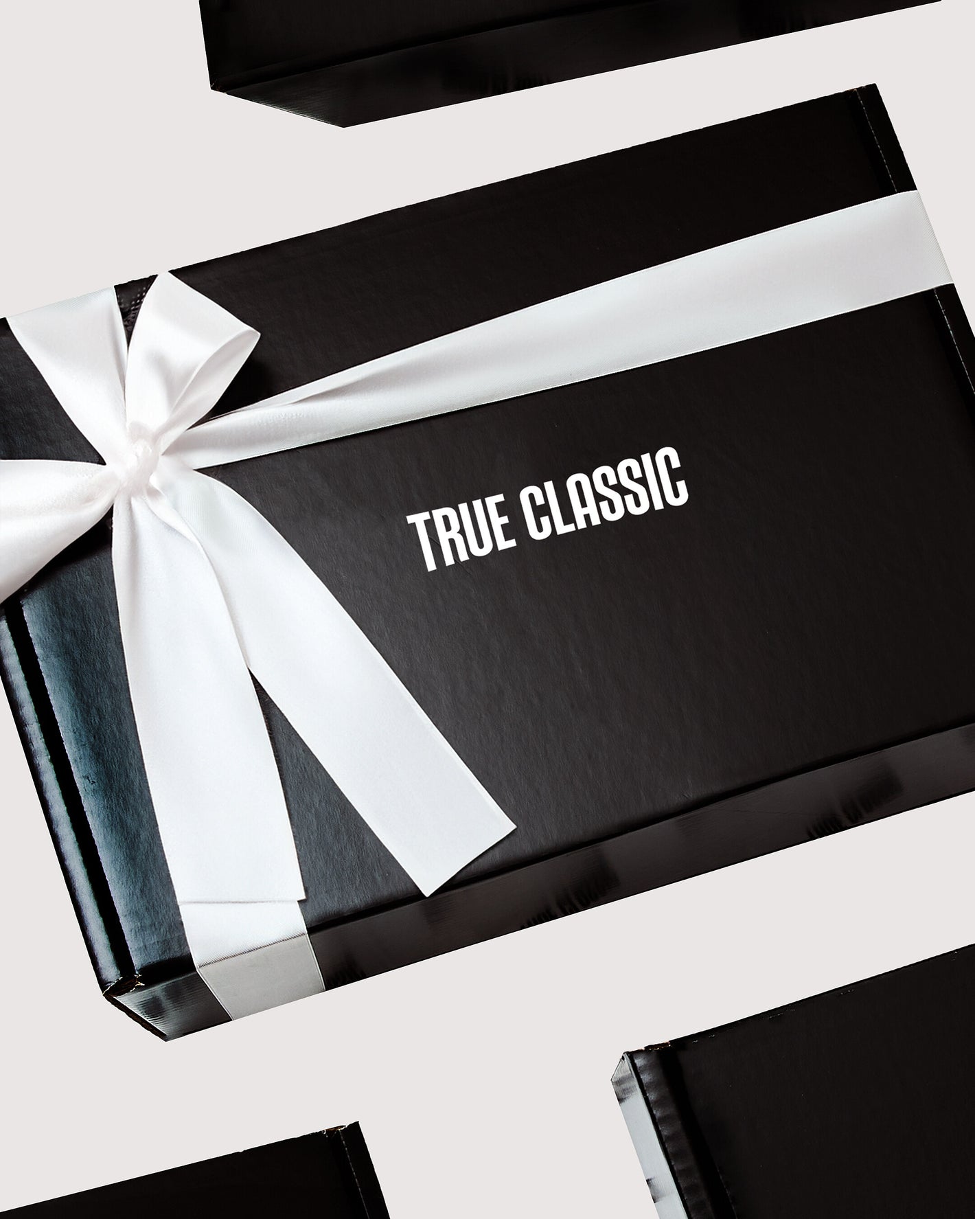 Gift Box with TRUE CLASSIC text and white satin ribbon.