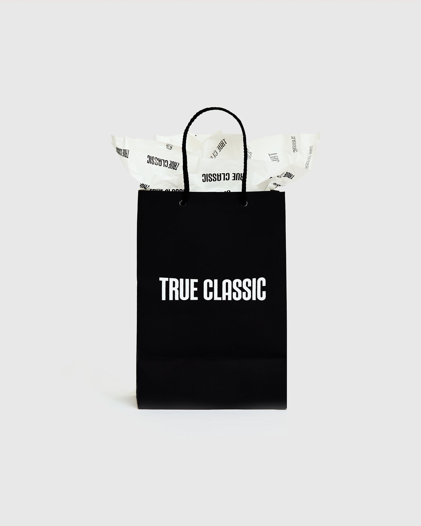 Gift Bag with braided handles and “TRUE CLASSIC” print.