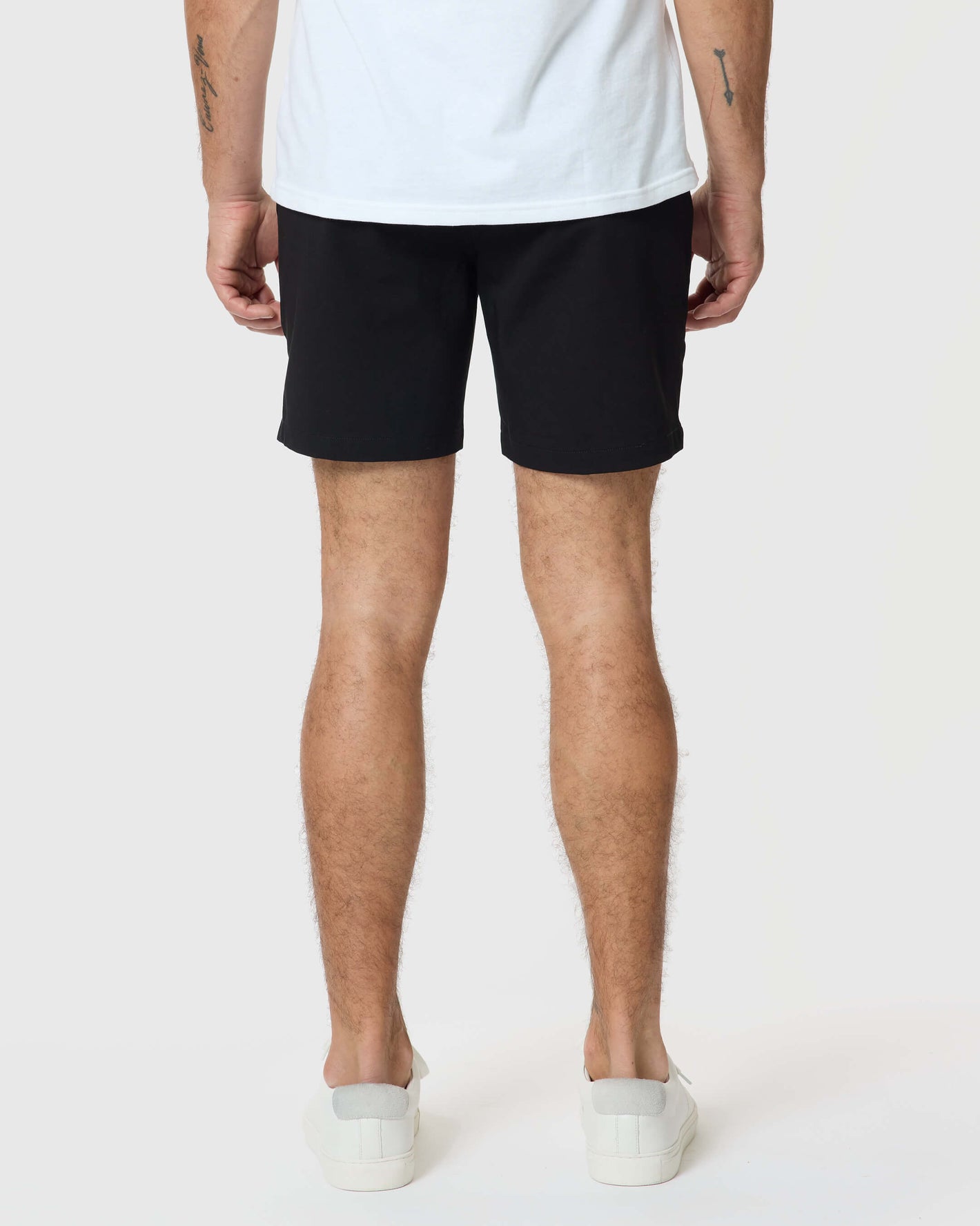 7 Black Classic Twill Shorts, worn with white sneakers, hem visible.