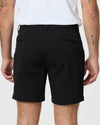 Man wearing 7 Black Classic Twill Shorts with buttoned back pockets.