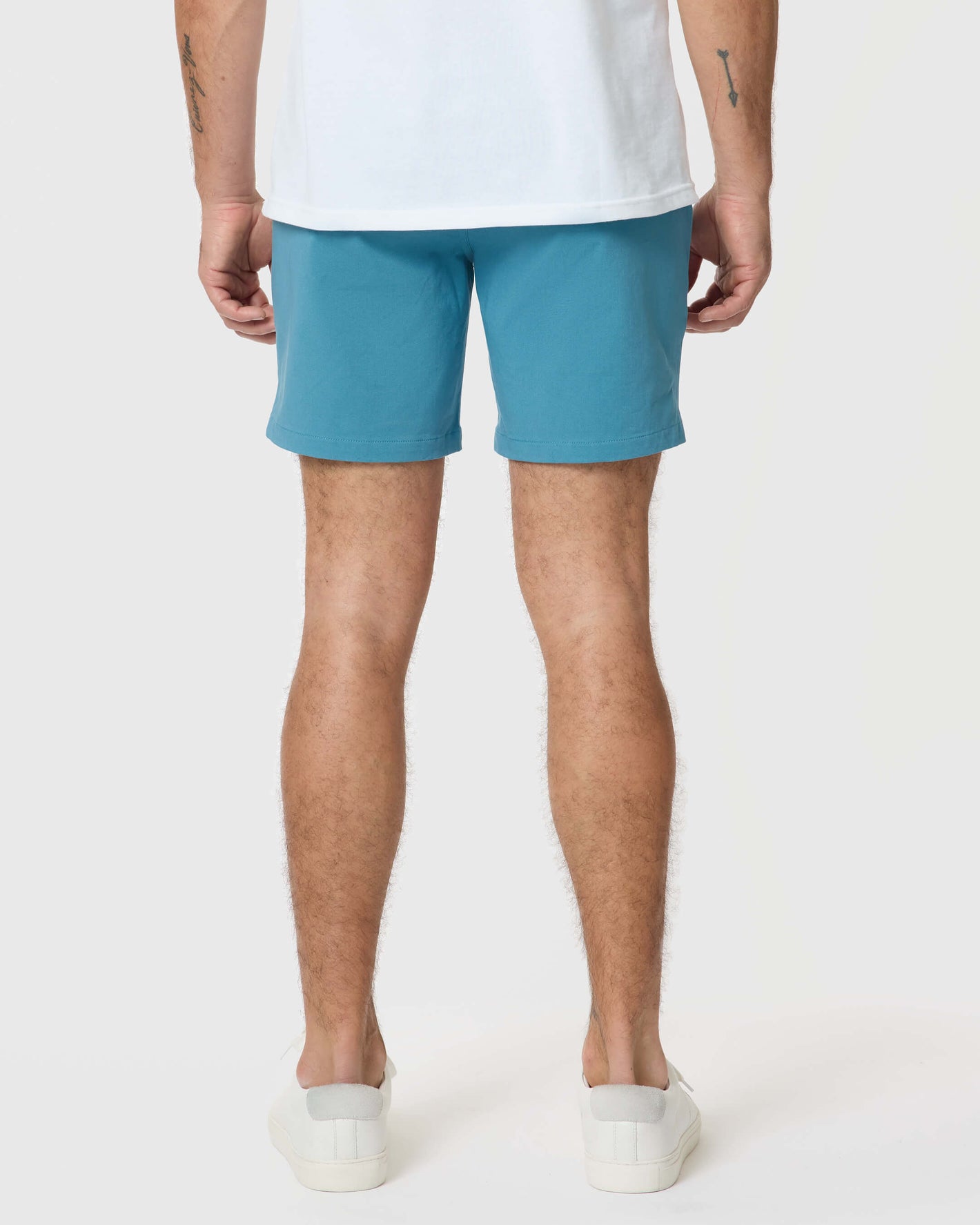 7 Harbor Classic Twill Shorts, mid-thigh length, with white sneakers.