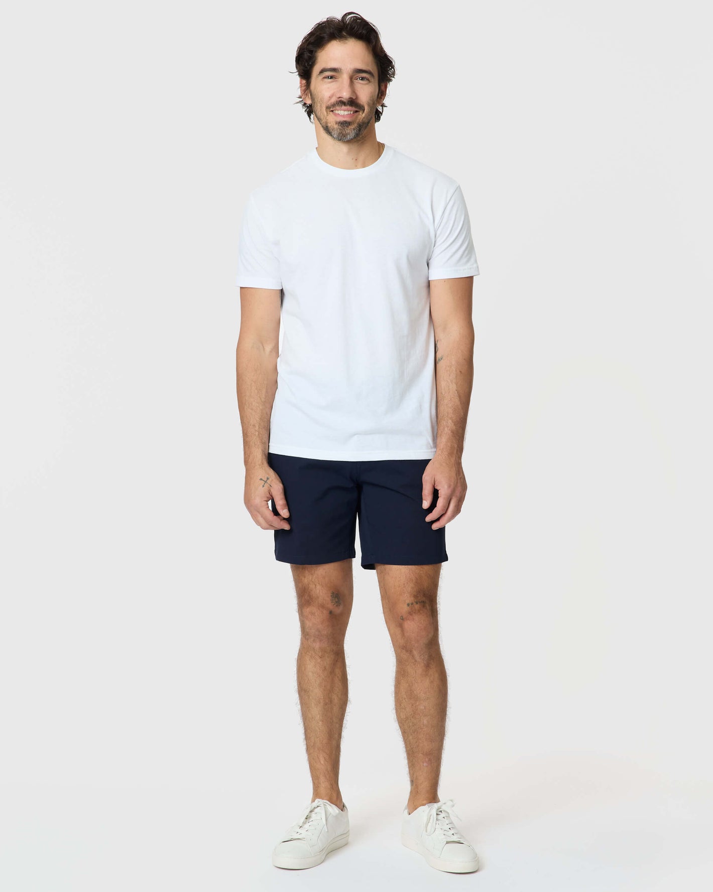 Man wearing 7 Navy Classic Twill Shorts with white T-shirt.
